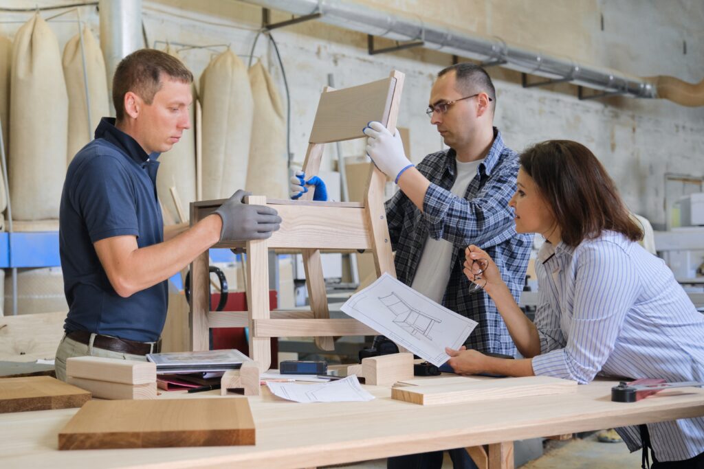 Group of working designers in carpentry workshop